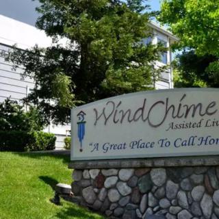 Entrance sign for WindChime Apartment Complex surrounded by greenery.