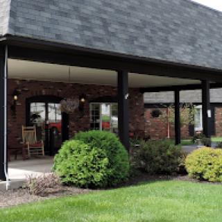 A well-maintained commercial building with a landscaped front yard.