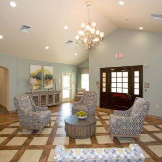 A modern living room with elegant lighting and comfortable seating arrangements.
