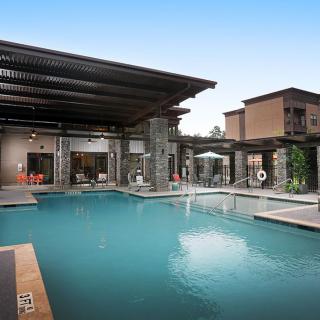 A luxurious outdoor swimming pool with modern architecture.