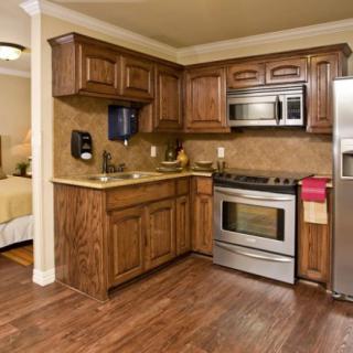 A cozy kitchen with wooden cabinets and stainless steel appliances.