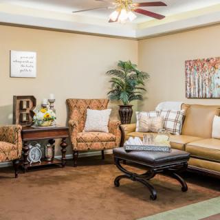 A cozy living room with a sofa, armchairs, and stylish decor.