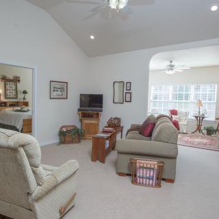 A cozy living room with comfortable seating and a TV.