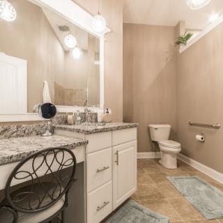 Elegant bathroom featuring a granite countertop vanity and modern fixtures.