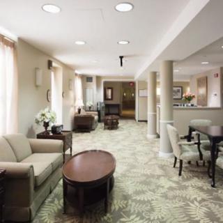 A modern lobby area with comfortable sofas, coffee tables, and decorative elements.