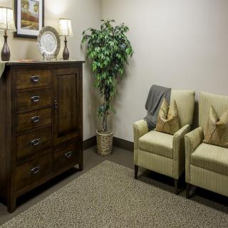 A cozy waiting room with comfortable chairs and elegant decor.