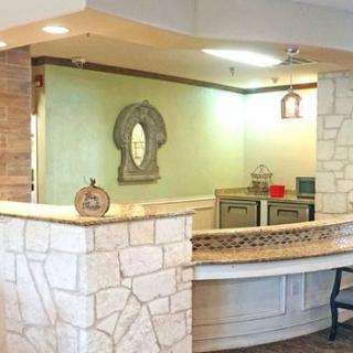A reception area with a stone desk and decorative elements.