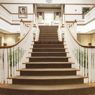 A grand staircase with elegant balustrades in a spacious interior.