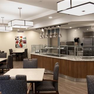 A modern dining area with sleek lighting fixtures and comfortable seating.