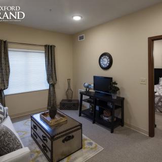 A cozy living room with a television and decorative items.