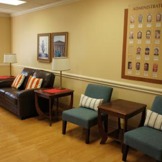 A cozy waiting room featuring comfortable seating arrangements and decorative elements.