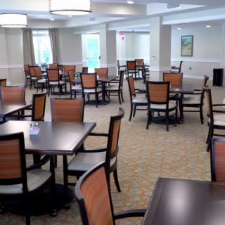 An empty dining room with arranged tables and chairs.
