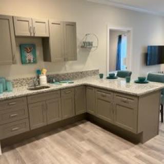 Modern kitchen with light brown cabinets and a clean countertop.