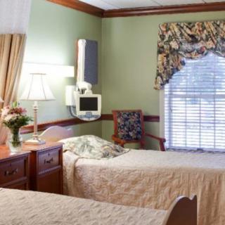 A well-lit hospital room with twin beds and elegant decor.