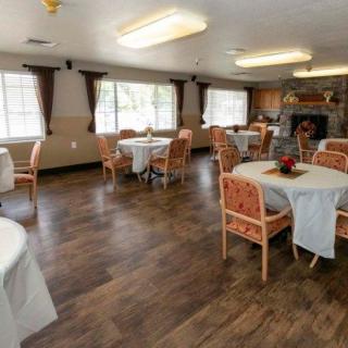 A spacious dining room with neatly arranged tables and chairs.