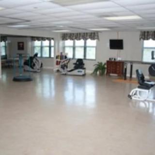 An indoor exercise room featuring various cardio machines.