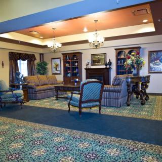 A well-furnished hotel lobby with seating arrangements and decorative elements.
