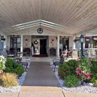 A charming front porch with outdoor seating and well-maintained landscaping.