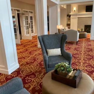 A cozy living room with elegant furniture and a decorative carpet.