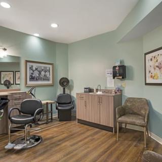 A modern hair salon interior with styling chairs and a waiting area.