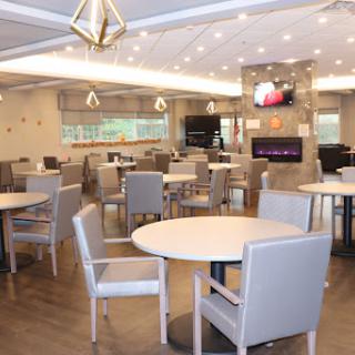 A modern dining room featuring ample seating and contemporary decor.
