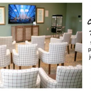 A cozy room with arranged seating facing a television.