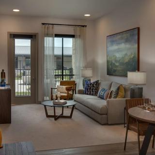 A modern and cozy living room with a large sofa, coffee table, and stylish decor.
