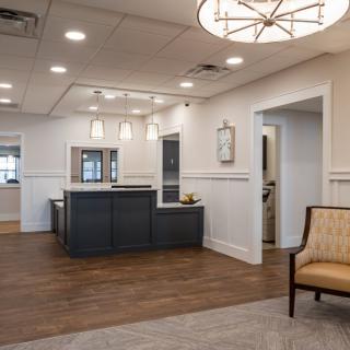 A modern reception area with stylish lighting and wood flooring.
