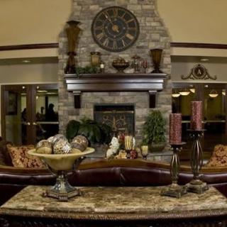 A cozy living room with a stone fireplace and elegant decor.