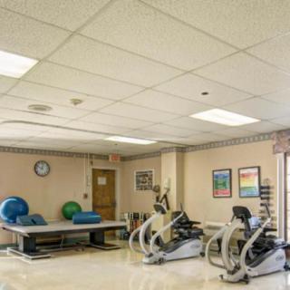 An indoor rehabilitation and therapy room with exercise equipment.