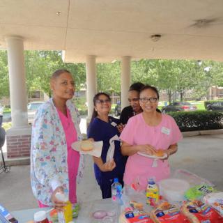 Participants enjoying a community event with food and smiles.