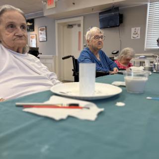 Seniors enjoying a meal together in a community dining area.