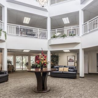 Spacious lobby area with modern furnishings and decorative plants.