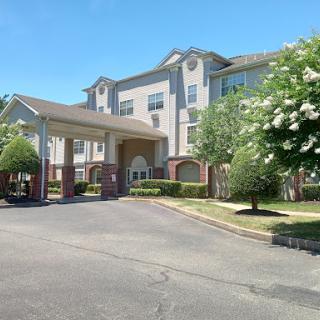 A welcoming view of a hotel with a spacious entrance and well-maintained landscaping.