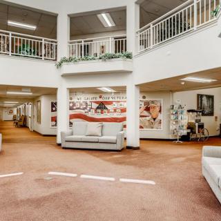 A spacious lobby area with modern furnishings and artwork displayed on the walls.