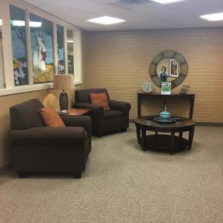 A cozy living room setup featuring comfortable seating and a stylish table.