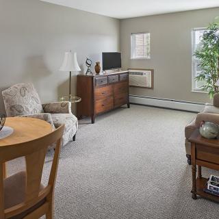 A cozy living room with furniture, a TV, and decor.