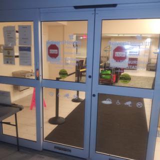 A well-lit entrance with clear signage, showcasing a waiting area and decorative features.