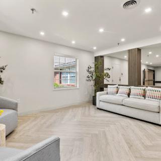 A stylish and modern living room featuring comfortable seating and bright lighting.
