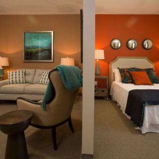 A stylish interior space divided into a cozy living room and a comfortable bedroom.