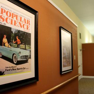 A framed vintage Popular Science magazine cover hanging in a hallway.