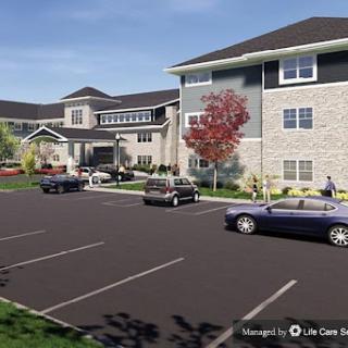 A modern apartment complex featuring well-designed architecture and a spacious parking area.