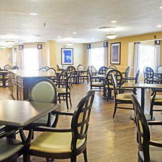 An empty dining area with multiple tables and chairs arranged neatly.