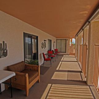 A sunlit porch with chairs and decorative elements.