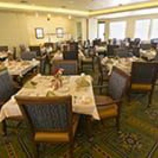 A dining room with neatly arranged tables and chairs.