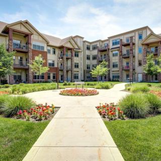 A modern apartment complex with a landscaped garden area.