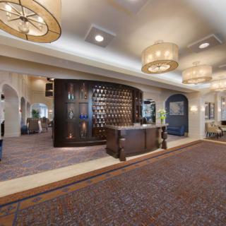 A spacious hotel lobby with elegant lighting and a welcoming reception desk.