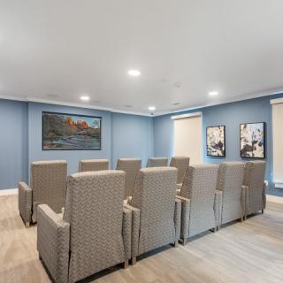 A modern theater room with comfortable seating and elegant decor.