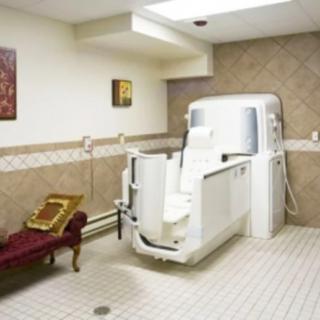 An accessible bathroom featuring a walk-in tub and tile flooring.