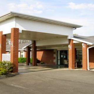 A brick building with a covered entrance and a canopy.